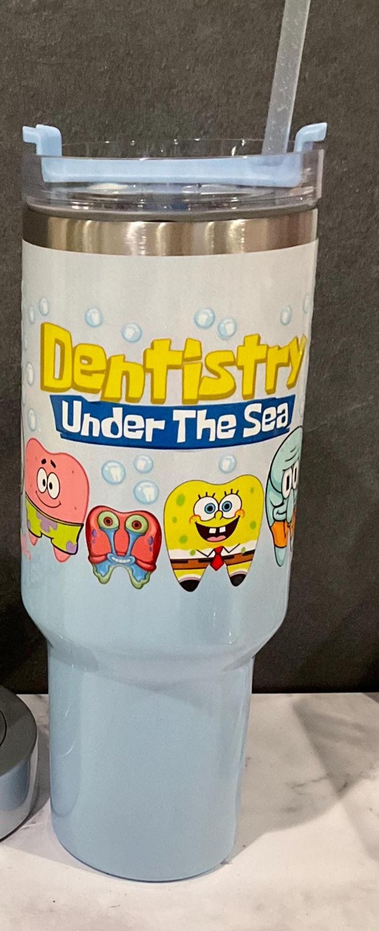 Teeth Obsessed 40oz stainless steel dental sponge starfish sea tumbler with handle and straw, vibrant ocean-themed drinkware.
