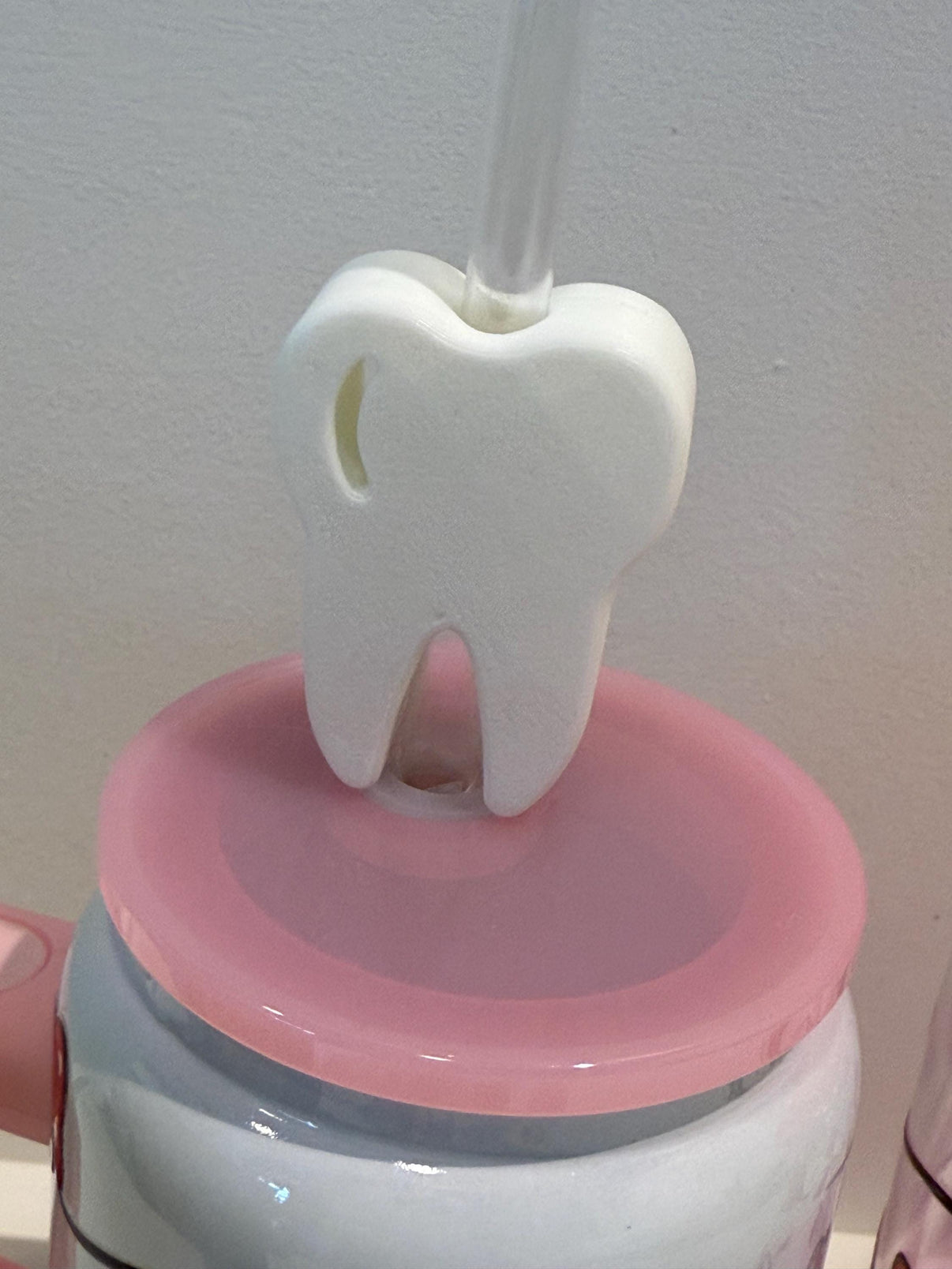 White drinkware with a tooth-shaped straw topper, perfect as a dental assistant gift by Teeth Obsessed.