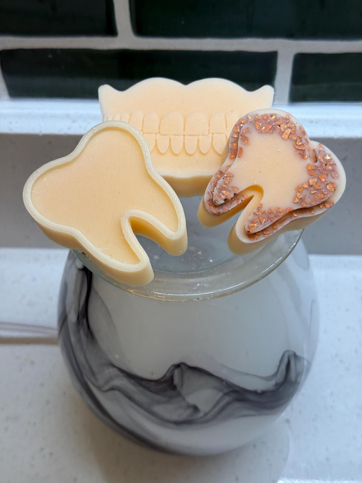 Teeth Obsessed orange and cream tooth wax melts, freshies for vents, with vibrant orange and creamy white color.
