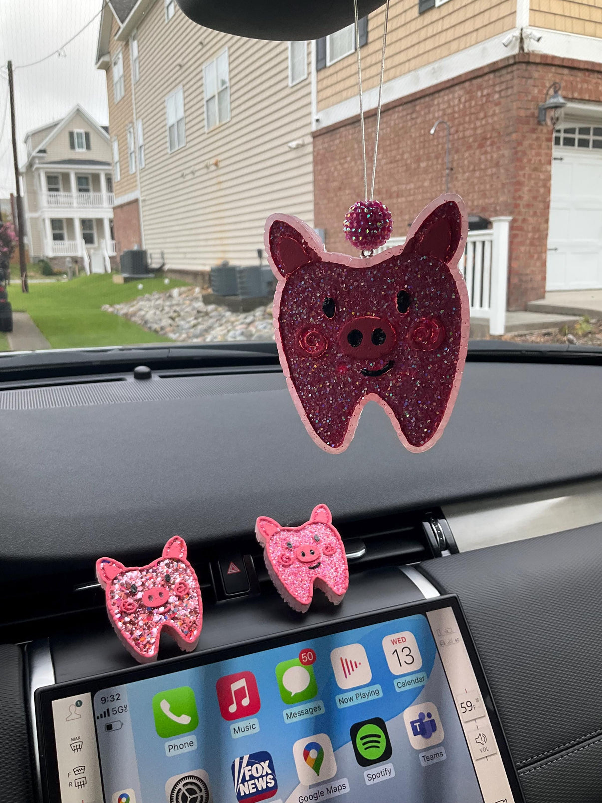 Teeth Obsessed pig tooth car freshener vent clip with hanging tart-shaped air freshener for vehicle air vents.