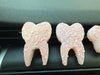 Teeth Obsessed Pink Tooth Car Fresheners Freshies vent tart with blueberry scent, shaped like a pink tooth for automotive air freshening.