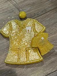 Teeth Obsessed yellow scrub top and vent car freshener with tart scent, designed for freshening car air and adding a pop of color.