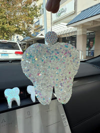 White glitter teeth-shaped car freshener from Teeth Obsessed, designed for vents and tart scent, adds a fun touch to your vehicle interior.