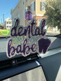 Dental Babe Purple Tooth car freshie from Teeth Obsessed, peach-scented vent tart with a fun tooth design.
