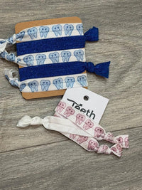 Blue smiling teeth dental hair ties from Teeth Obsessed, featuring fun tooth design and secure elastic hair ties.