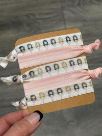 Dental Team Hair Ties by Teeth Obsessed, colorful hair ties and clips featuring dental-themed designs for dental professionals.