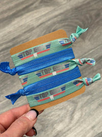 Teeth Obsessed Top Gum Dental Hygiene Hair Ties in various colors, designed for gentle hair holding and dental-themed style.