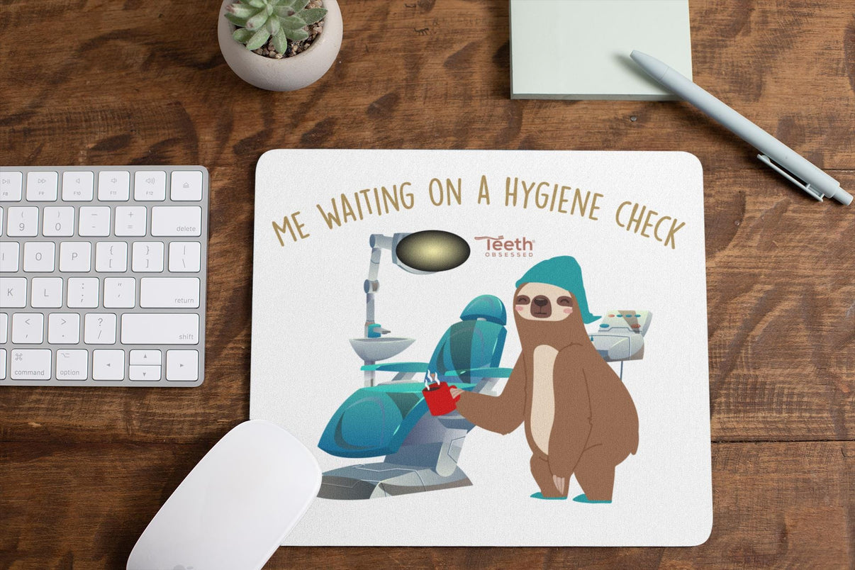 Teeth Obsessed mouse pad featuring a design titled "Waiting on a Hygiene Check" with a dental-themed illustration.