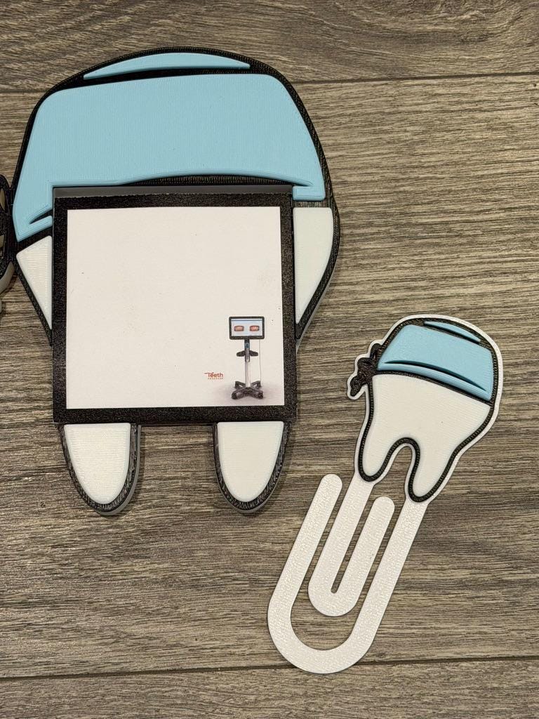 Teeth Obsessed magnet notepad holder featuring a white scrub cap design with pen holder, notepad, and paperclip accessories.