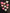 Assorted pink, peach, and iridescent acrylic tooth magnets for dental office decor on a black background.