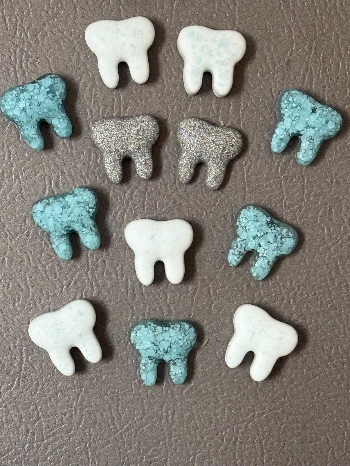 Teeth Obsessed teal, white, and grey tooth-shaped notes and magnet set on a white background.
