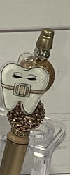 Teeth Obsessed gold Ortho Pubble pens and holders set, stylish dental-themed writing accessories with pen and holder combo.