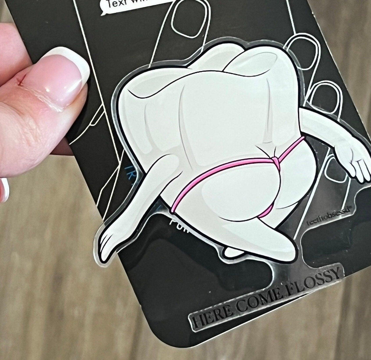 Mrs Flossy teeth-themed phone grip and stand by Teeth Obsessed, featuring a fun dental design for secure phone handling.