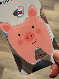 Teeth Obsessed pig tooth phone grip with a fun pig tooth design, used as a phone stand or grip for smartphones.