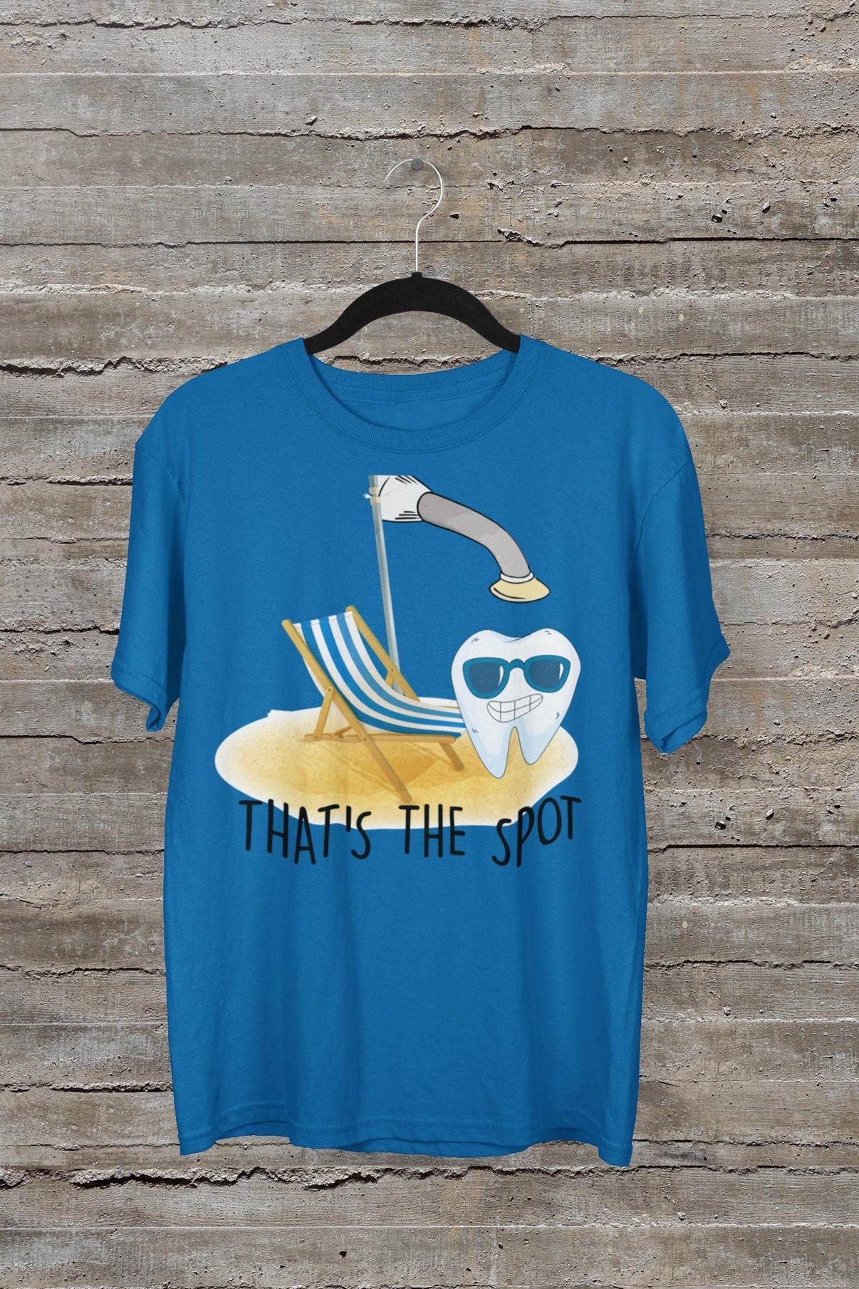 White "That's The Spot" curing light tooth shirt and pin by Teeth Obsessed, featuring dental-themed design and playful style.