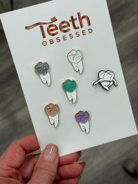 Turquoise Molar Dental Pins from Teeth Obsessed, featuring shirt and pin designs with tooth-themed graphics.