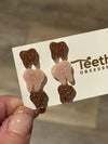 Rose gold dental earrings with Valentine design from Teeth Obsessed, featuring tooth-shaped charms on gold hooks.