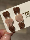 Rose gold dental earrings featuring Valentine-themed design from Teeth Obsessed, showcasing detailed tooth-shaped jewelry.